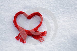 Bright red scarf on a background of white soft fluffy snow,  christmas attribute,  i love winter conÃÂept, welcome winter